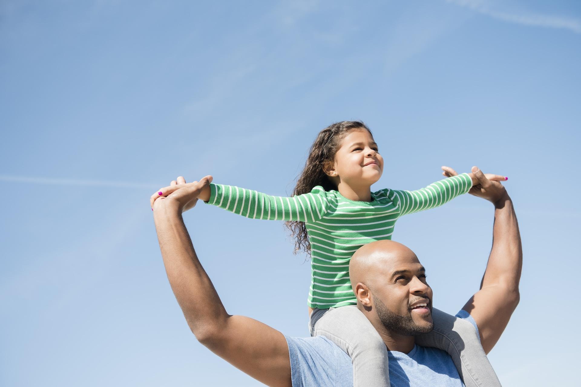 Father with his daughter on his shoulders