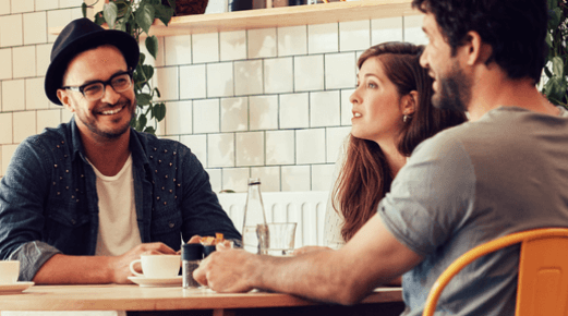 Three friends sitting at coffee table